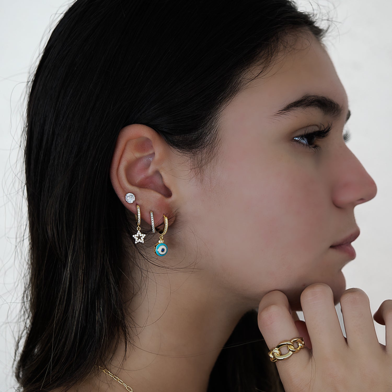 Model confidently showcasing the Turquoise Evil Eye Gold Earrings