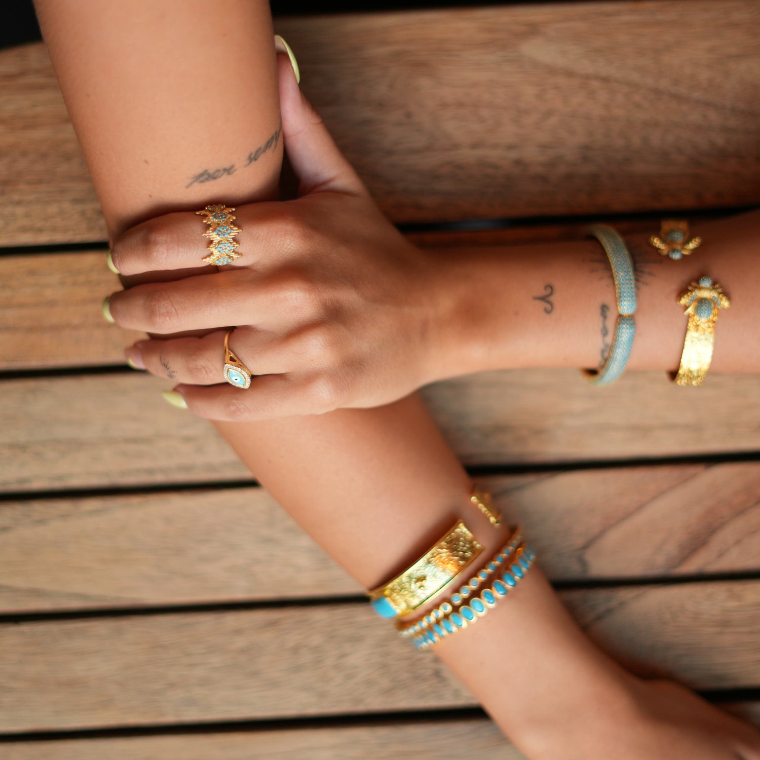 Sophisticated ring with a gold crown design and turquoise stones, made from 24k gold-plated brass and adjustable for versatile wear.