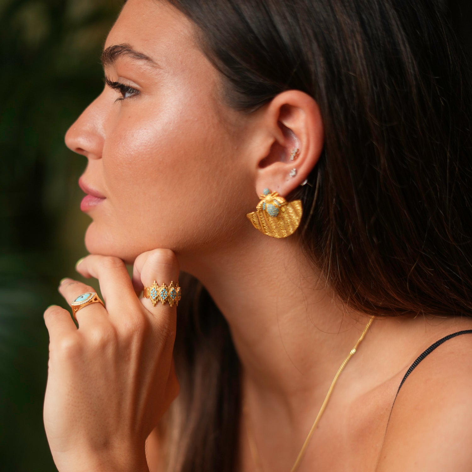 Chic statement ring featuring a crown design and turquoise stones, made from 24k gold-plated brass with an adjustable band for comfort.