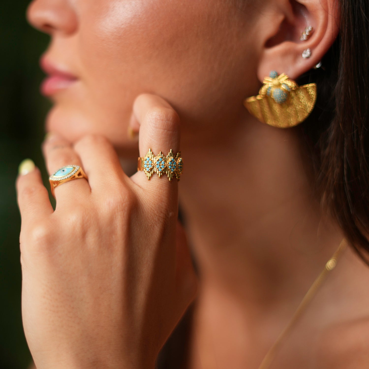 Elegant adjustable ring with a gold crown design and turquoise stones, crafted from 24k gold-plated brass for a regal and striking look.