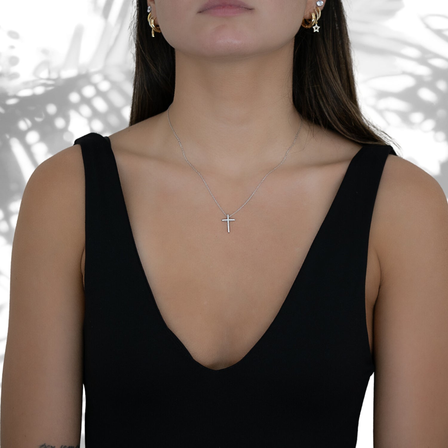 The Unique Cross Diamond Necklace beautifully adorning the model's neckline.