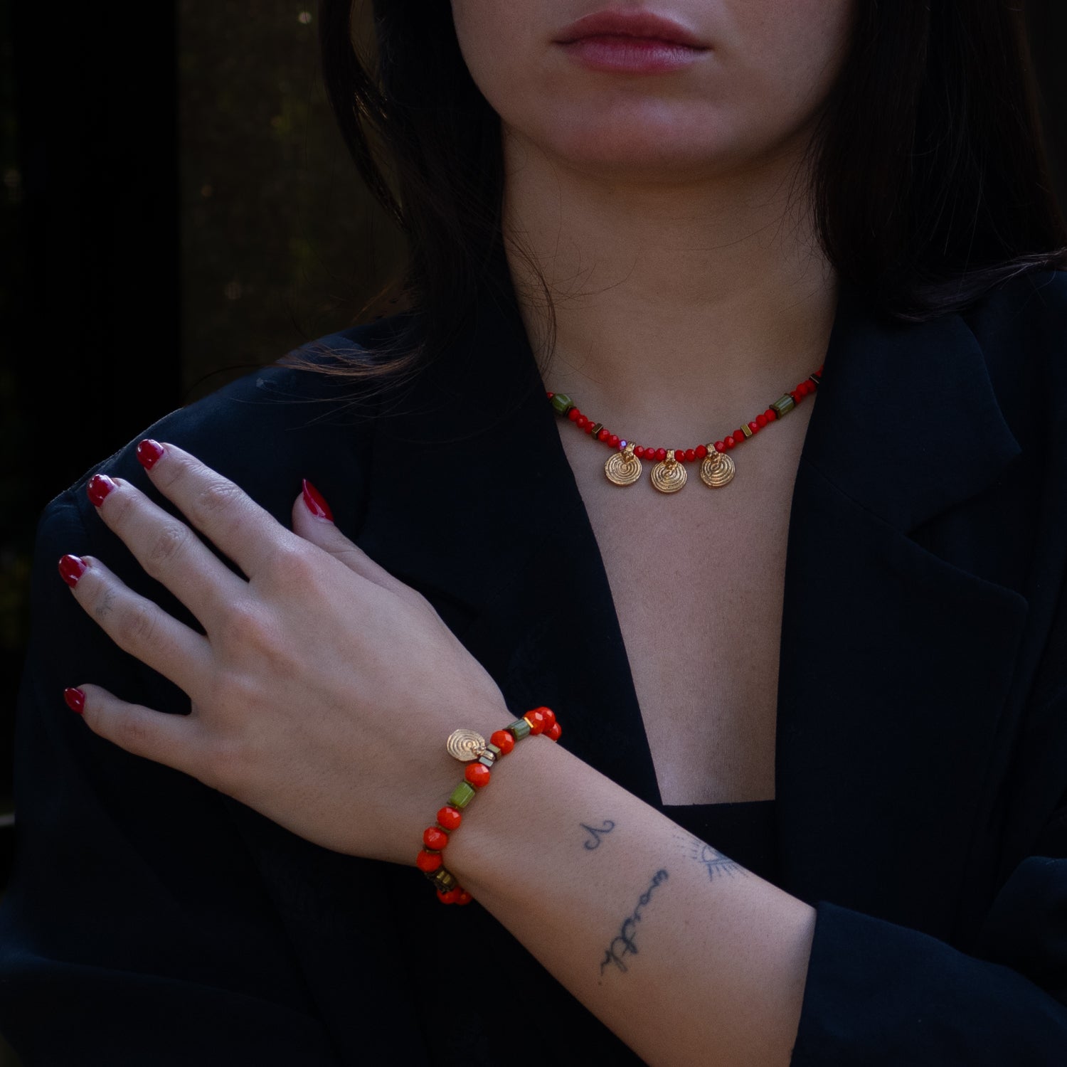 Energetic and Colorful Gold Spiral Charm Choker Necklace with Orange and Green Beads for a Bold Statement