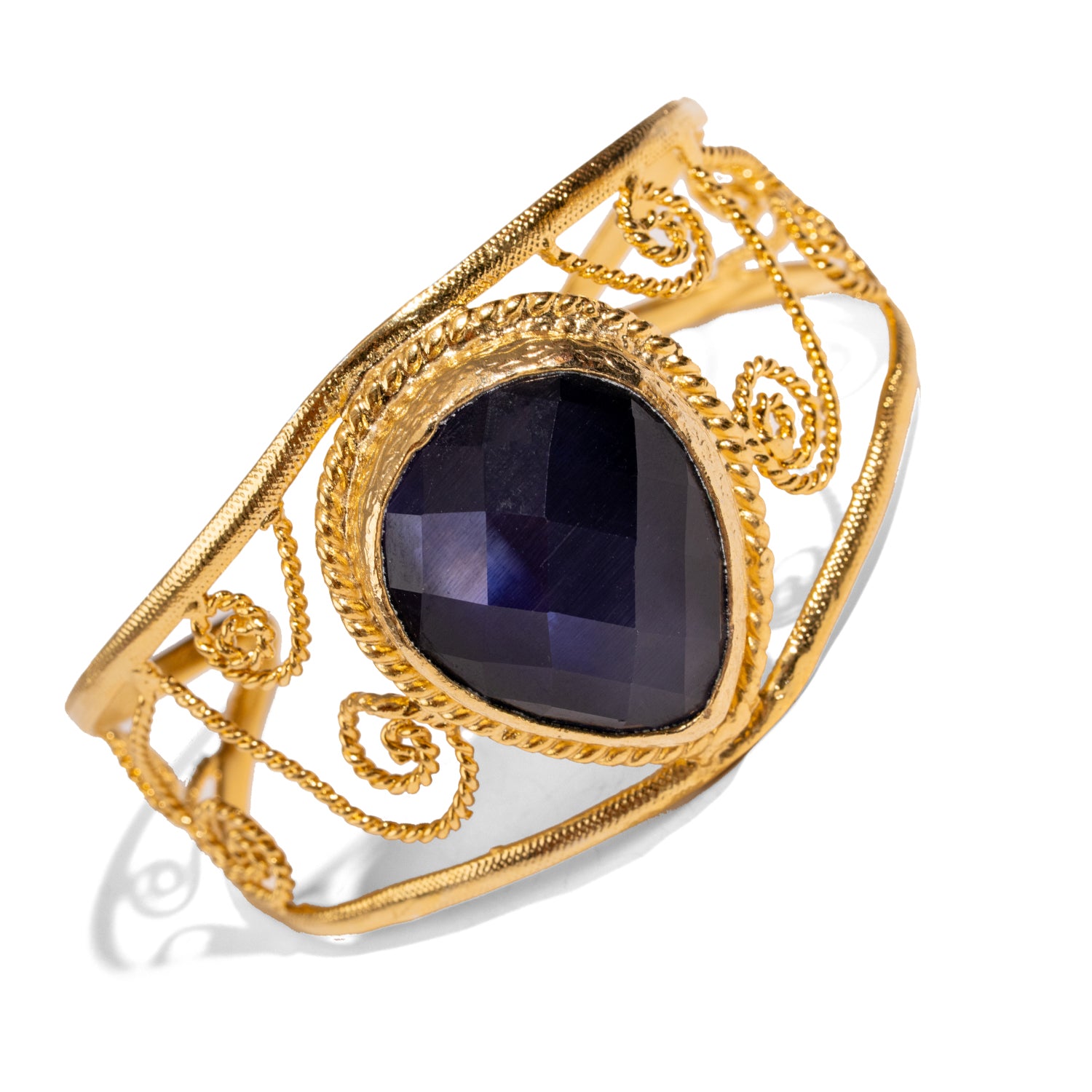 Chunky vintage cuff bracelet in 24k gold-plated bronze, navy blue cat eye stone, ornate gold swirl accents, bold statement style