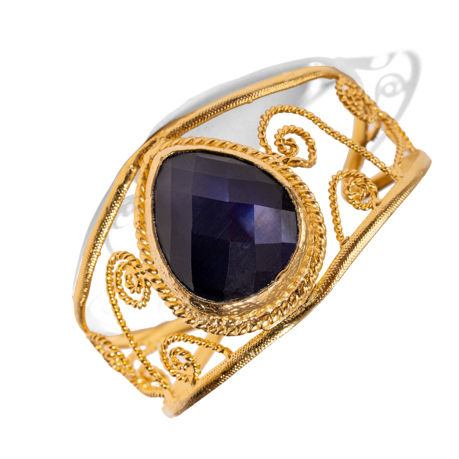 Chunky vintage cuff bracelet in 24k gold-plated bronze with navy blue cat eye stone and ornate gold swirl design