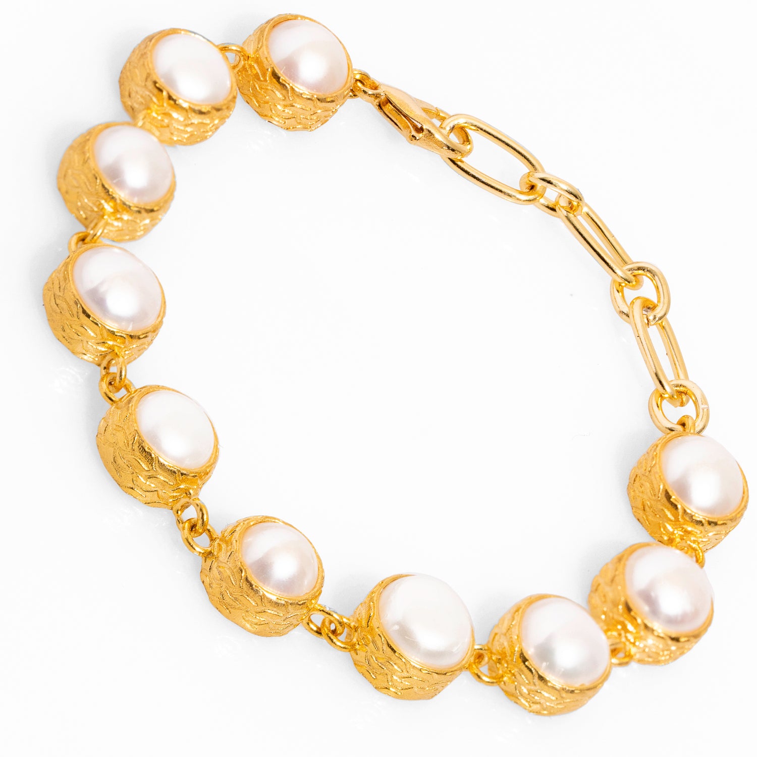 Luxurious vintage-style tennis bracelet adorned with round pearls and 24k gold plating, perfect for weddings or special events.