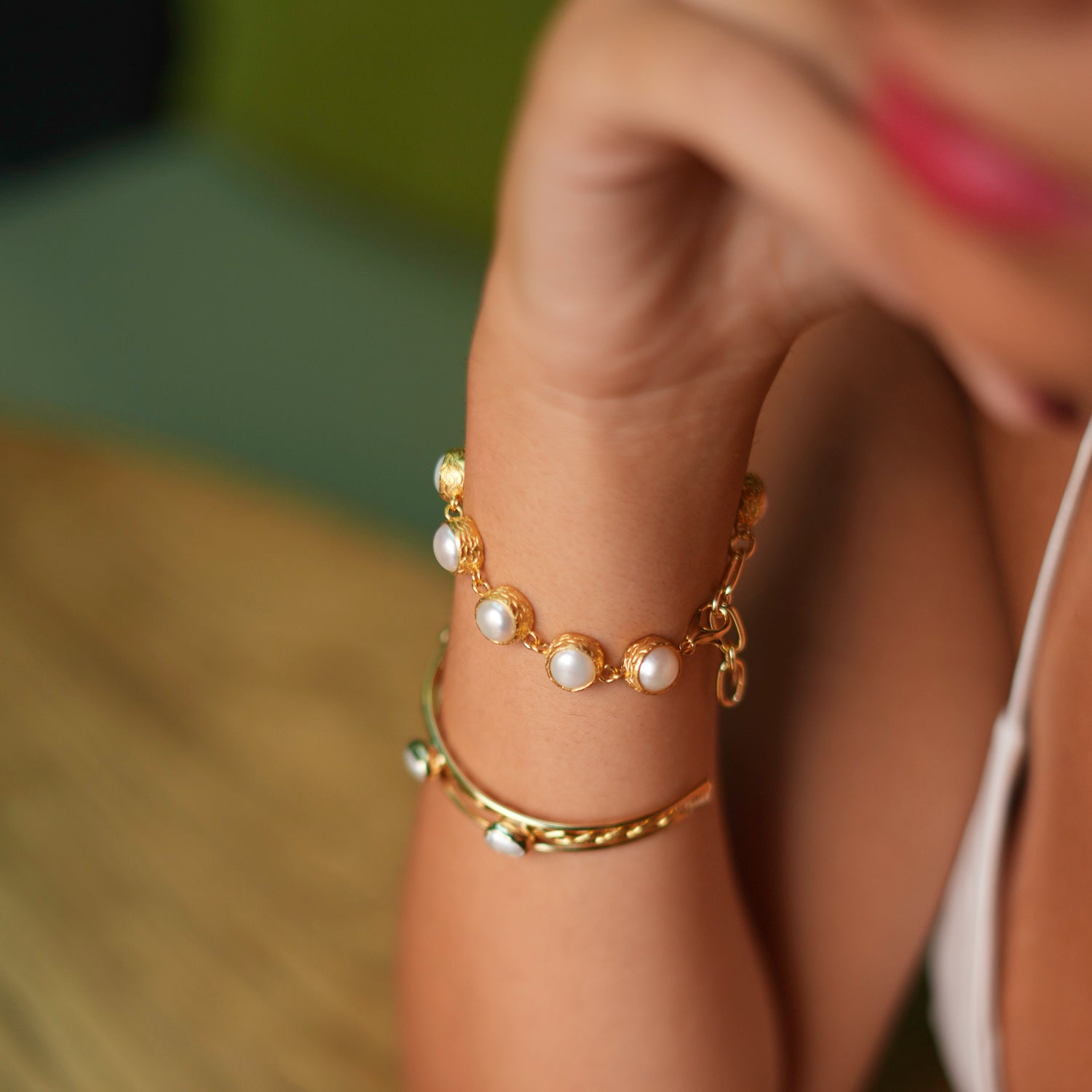 Classic 24k gold-plated pearl tennis bracelet with vintage-inspired settings, designed to add a touch of elegance to any outfit.