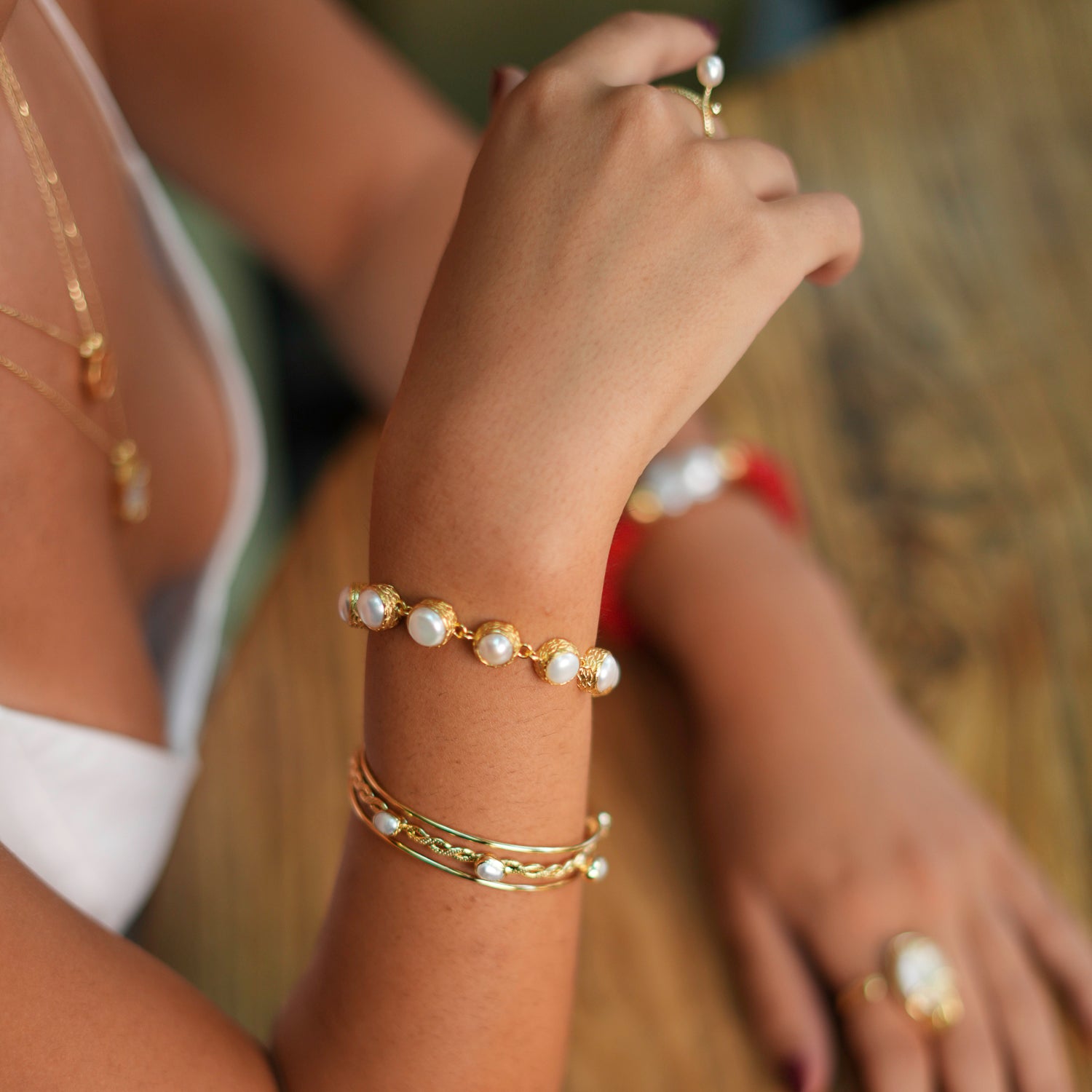 Vintage-inspired pearl tennis bracelet with 24k gold-plated craftsmanship, offering a classic and luxurious accessory for any occasion.