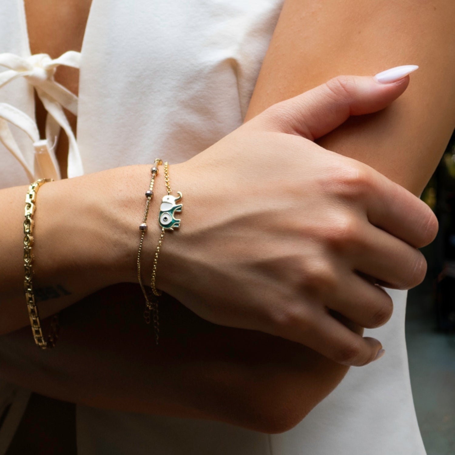 Gold Chain Bracelet with Green and White Enamel Elephant Charm and Evil Eye Symbol