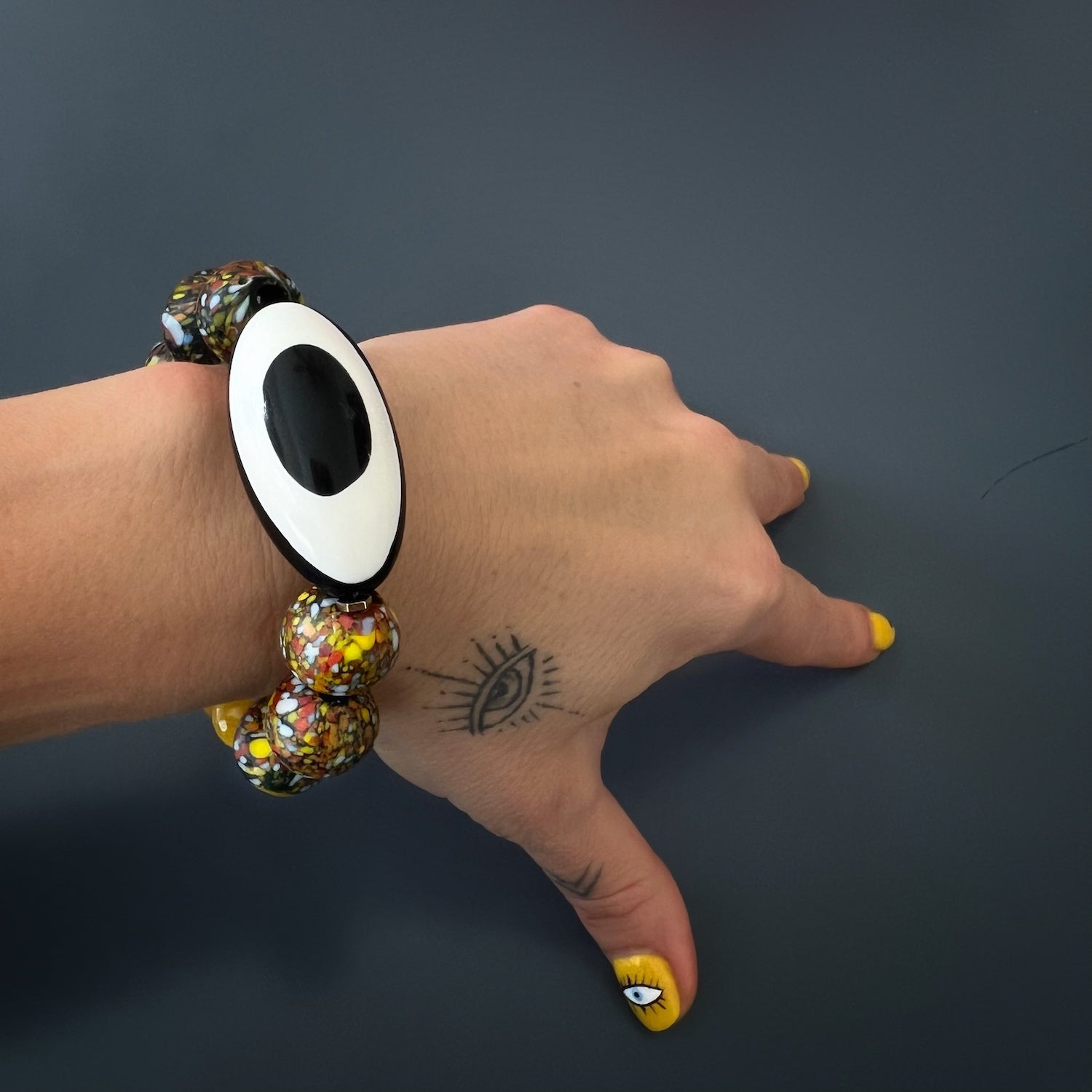 A model wearing Black and white Nepal Eye bead combined with chunky African and yellow jade beads.