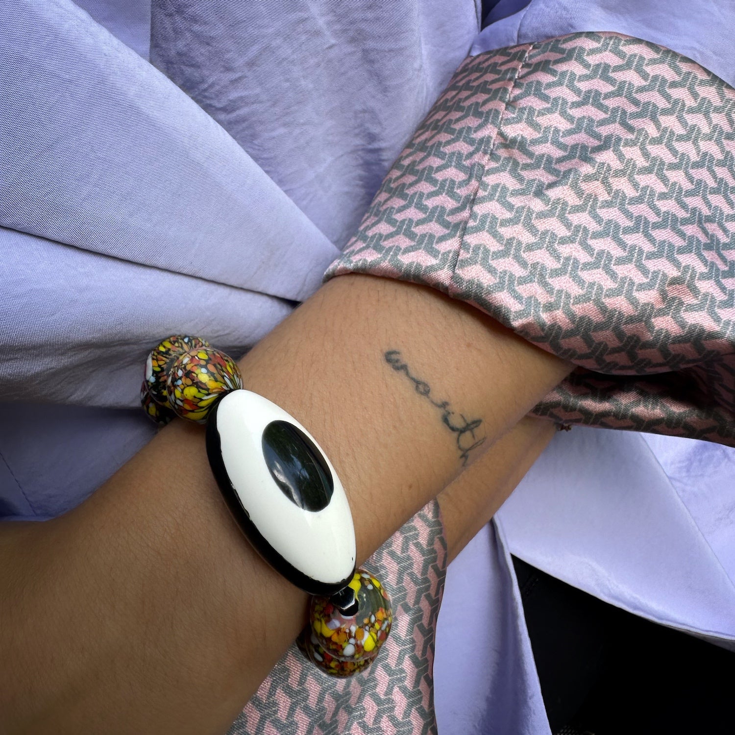 Model wearing African Chunky Eye Bracelet; Black and white Nepal Eye bead with yellow jade and African beads on high quality stretchy jewelry cord