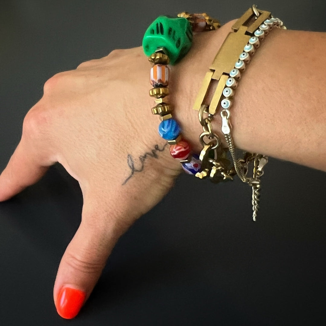 See the African Colors Women Bracelet on the hand model's wrist, radiating joy and celebration with its colorful glass beads and African beads.