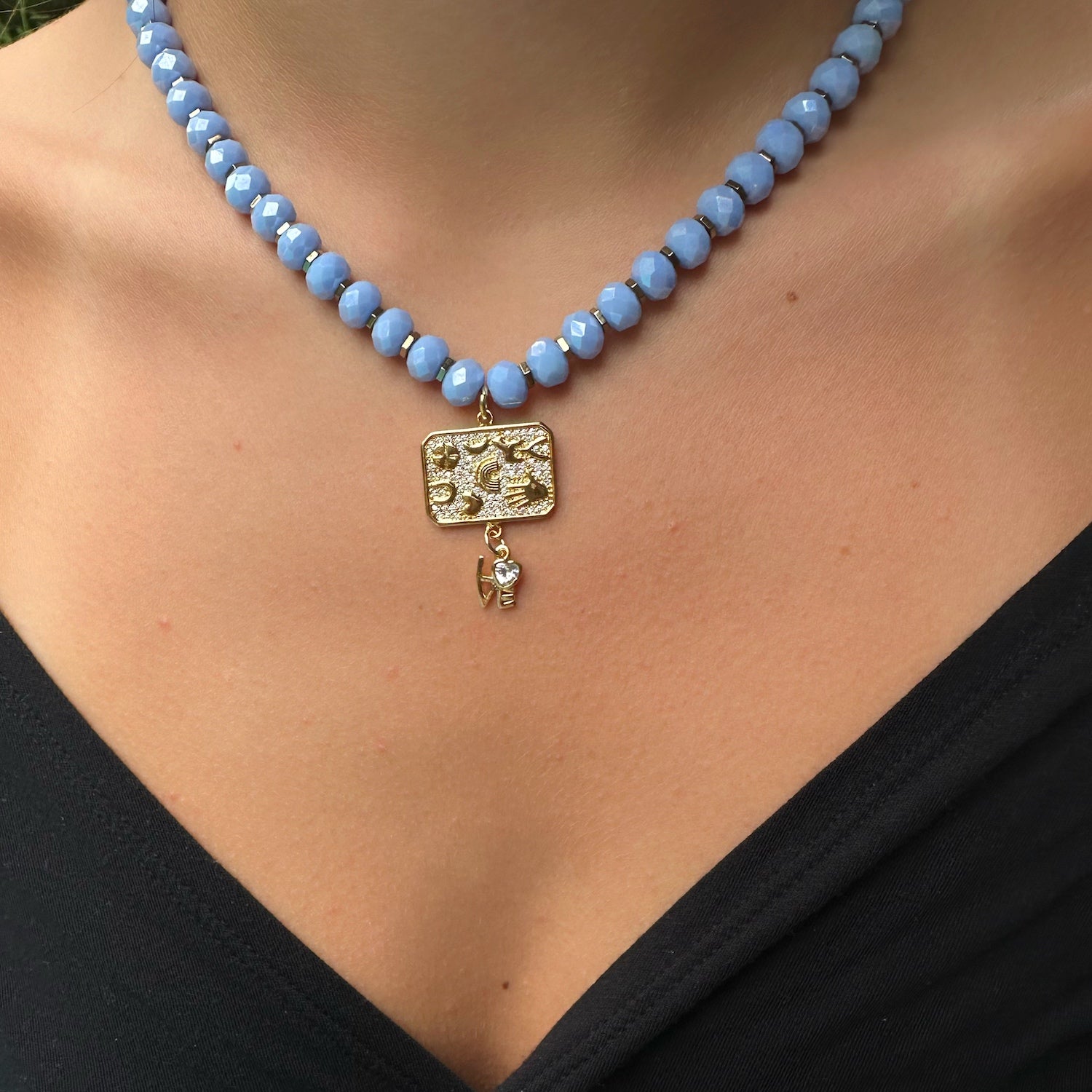 A close-up of the Best Wishes Magical Talisman Necklace on the model's neck, showing the intricate details.