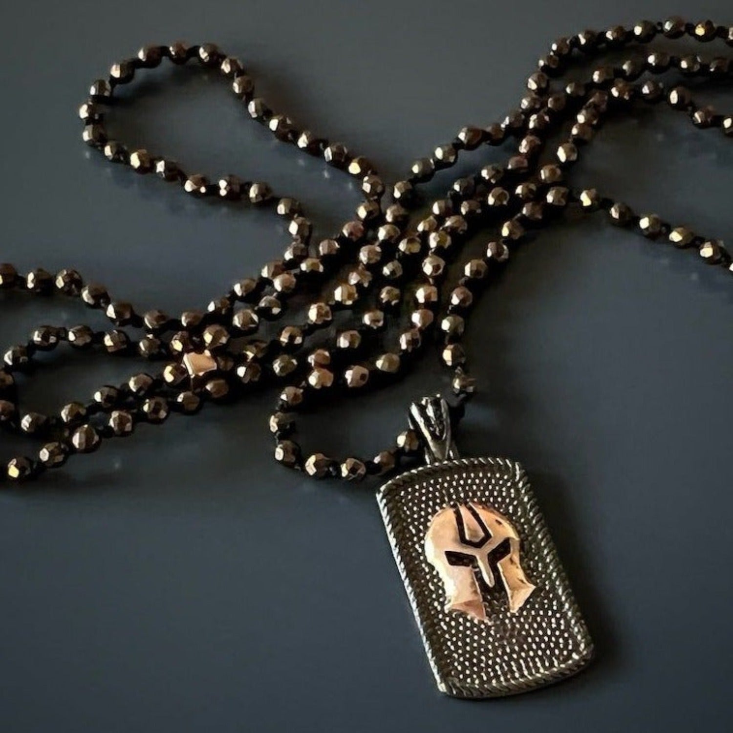 Elegant brown hematite bead necklace with striking silver gladiator pendant for fearless style.
