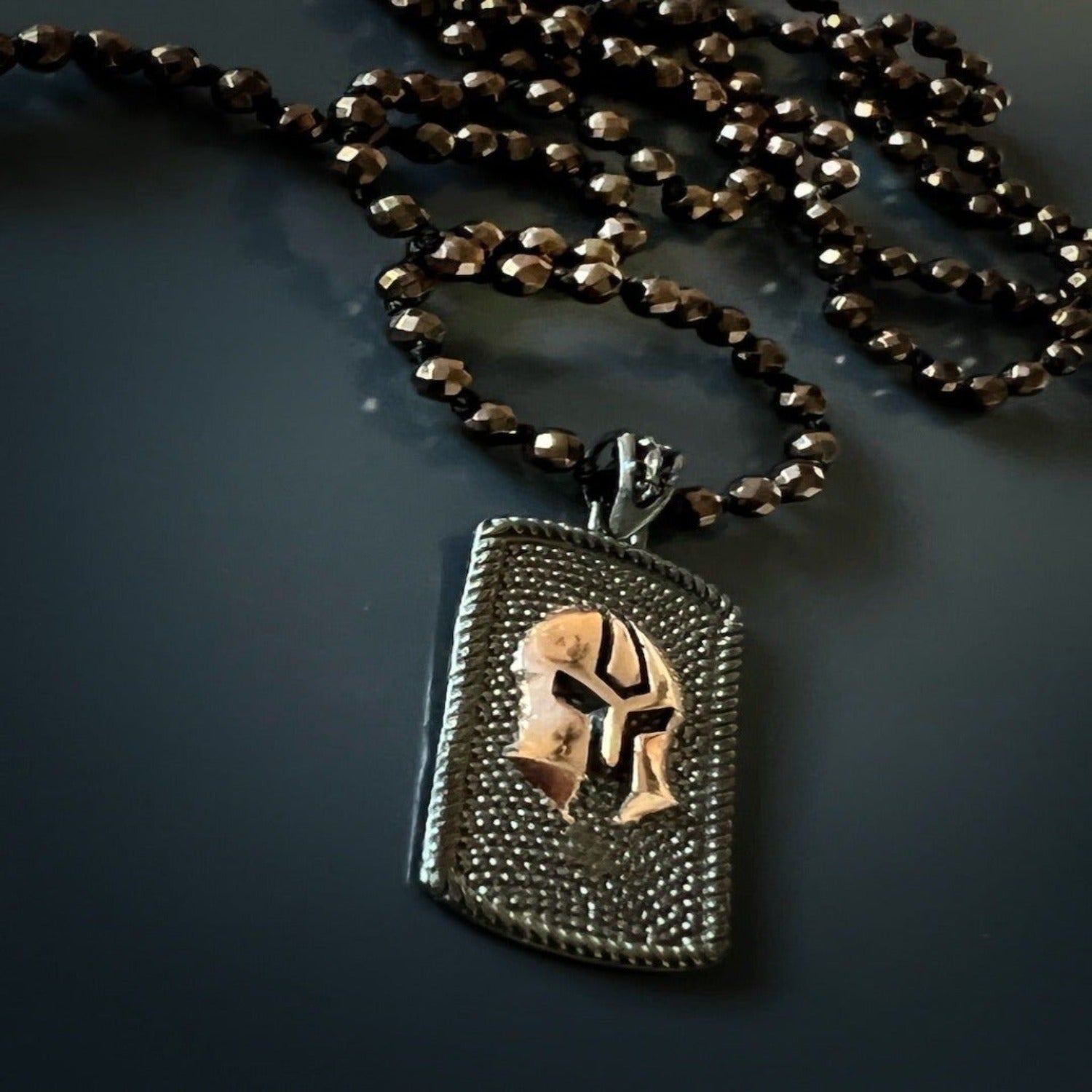 Gladiator warrior necklace with sterling silver pendant and balancing hematite stones.