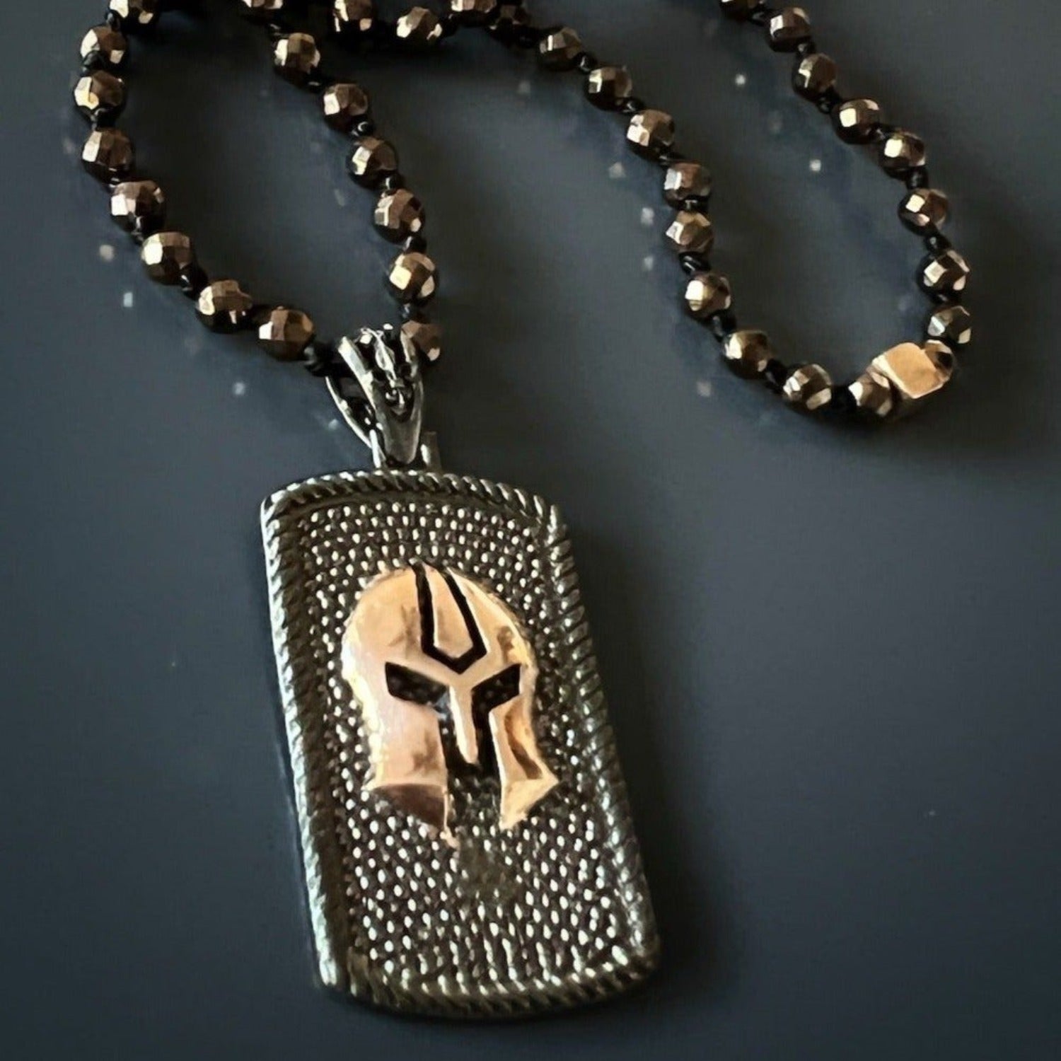 Handmade necklace for men combining strength of gladiator imagery with grounding hematite.