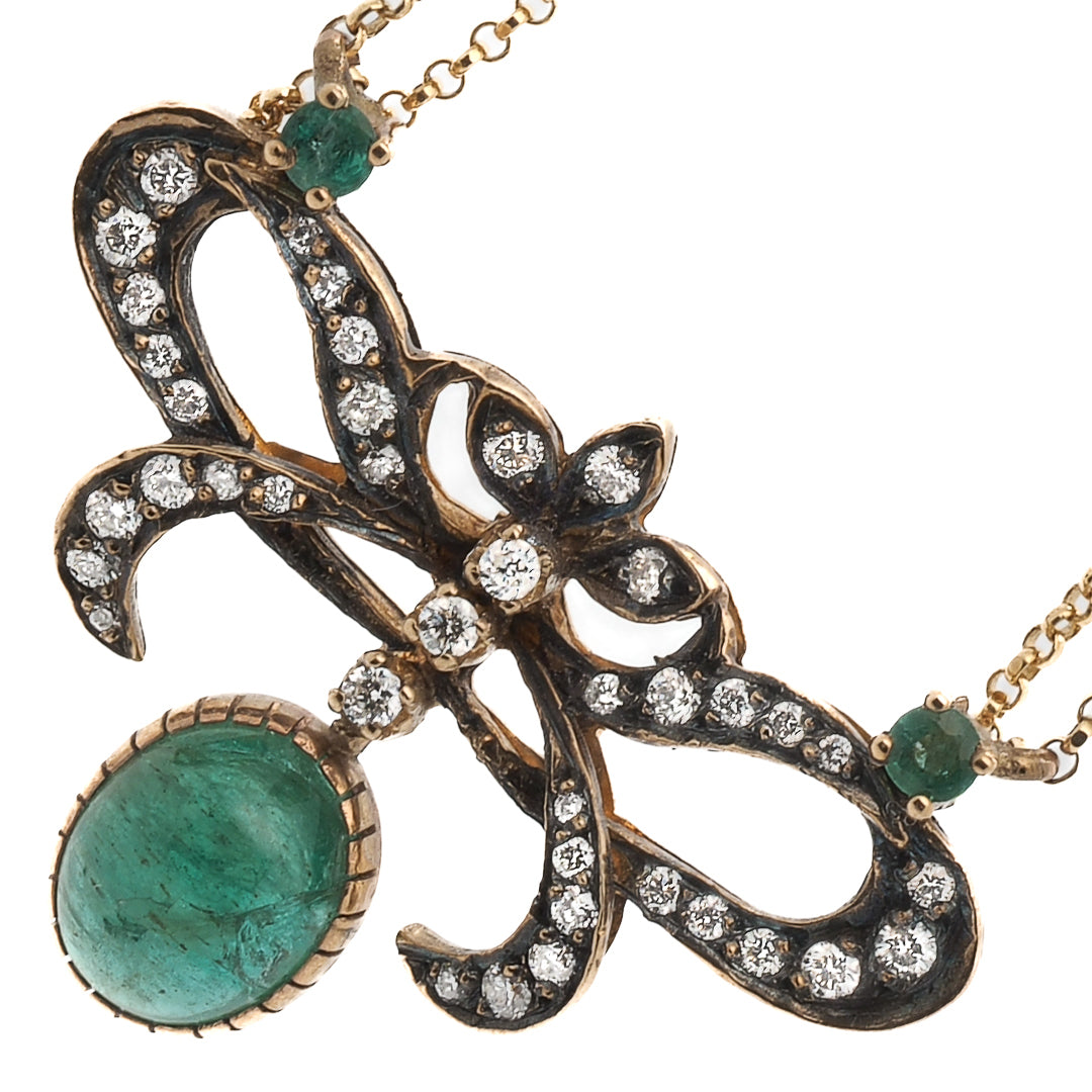 Emeralds weighing a total of approximately 3.91 Karat and diamonds weighing 0.40 Carat are used in this pendant necklace.