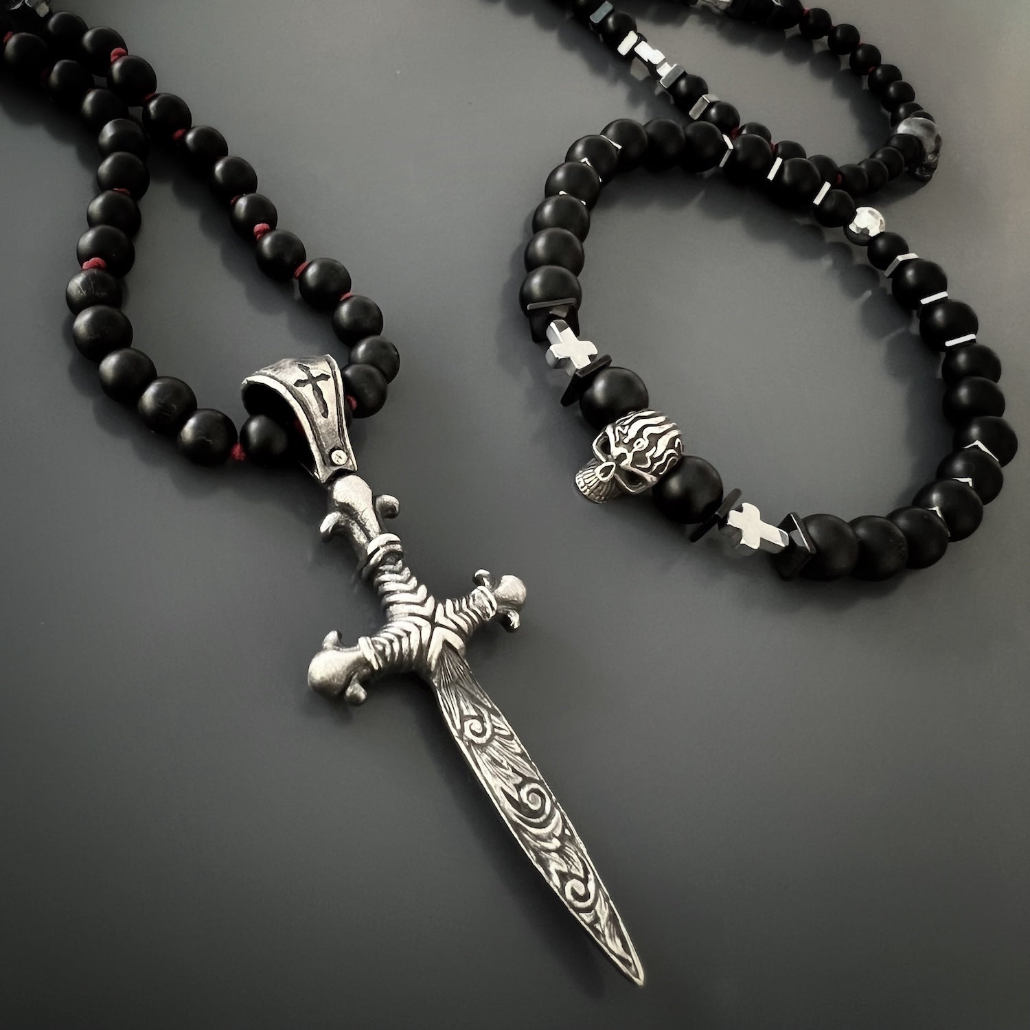 the Courage Onyx Skull Bracelet, beautifully highlighting its black onyx stones, sterling silver skull bead, and silver hematite cross beads.
