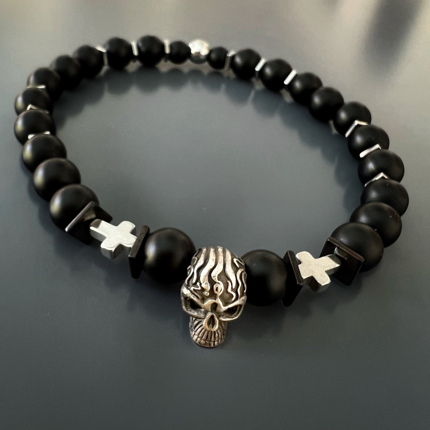 The Courage Onyx Skull Bracelet is a stunning handmade piece that embodies courage and fearlessness.