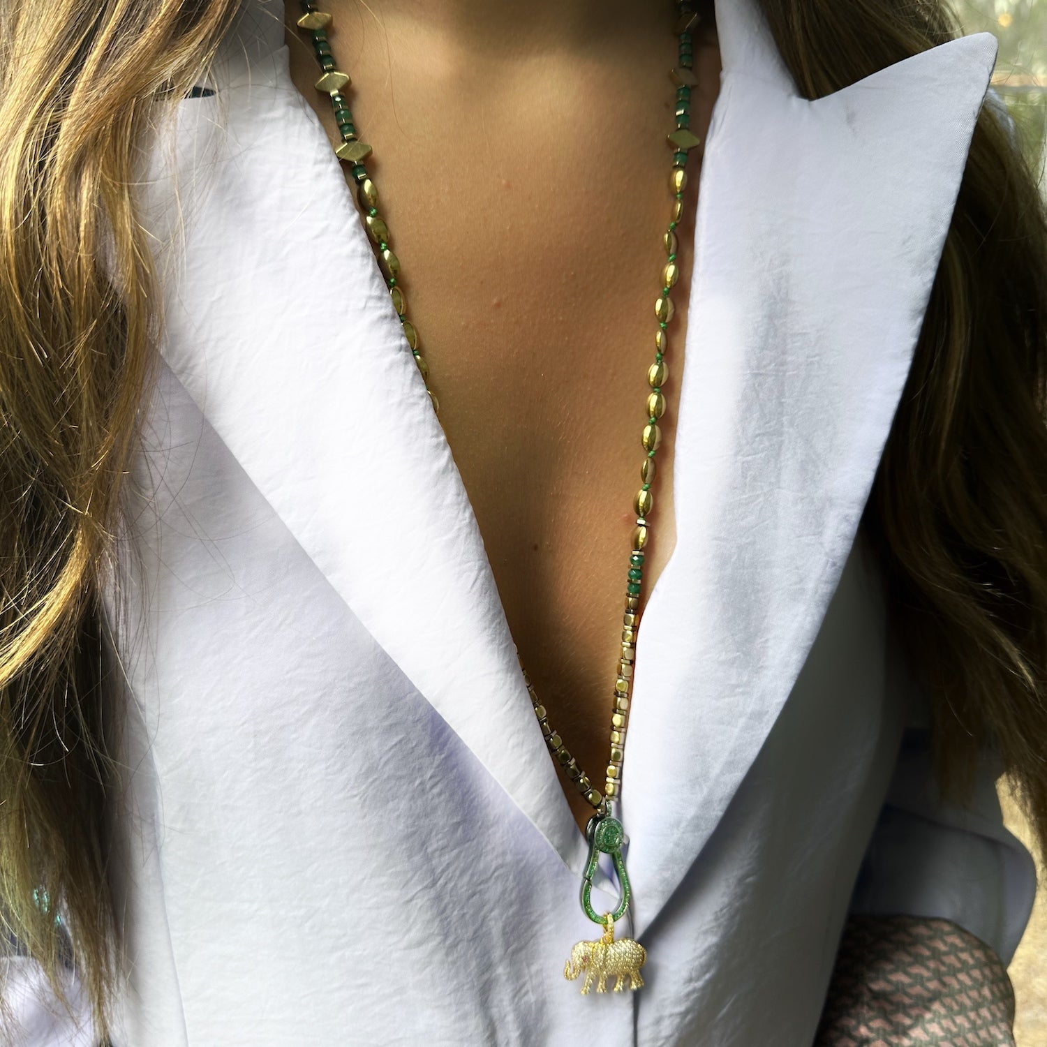 A model wearing the Diamond Elephant Golden Necklace, the pendant beautifully resting against her chest, showcasing the elegance and statement-making quality of the necklace when worn.