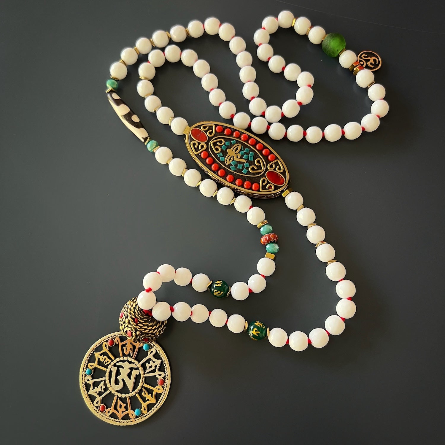 Talismanic Buddha Eye Necklace - Handmade jewelry with turquoise and coral stone accents, Nepal tube beads, and the sacred Om Mani Padme Hum mantra.