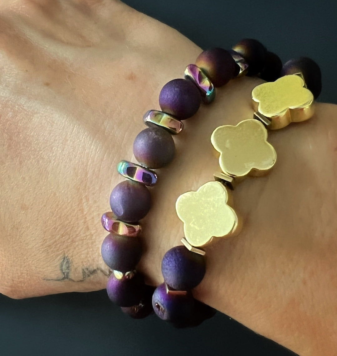 Hand model wearing Fleur de Li Agate Bracelet - Unique handmade jewelry with multicolor Hematite and Druzy Agate stone beads, showcasing elegance and symbolism