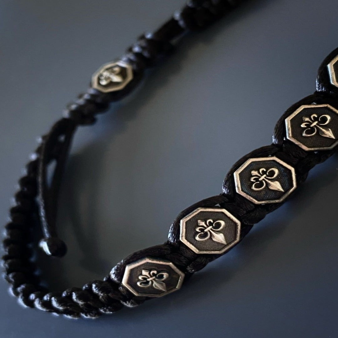 Handcrafted Fleur De Lis Men Bracelet - Unique and versatile handmade bracelet with a woven design, adjustable size, and silver Fleur De Lis charms