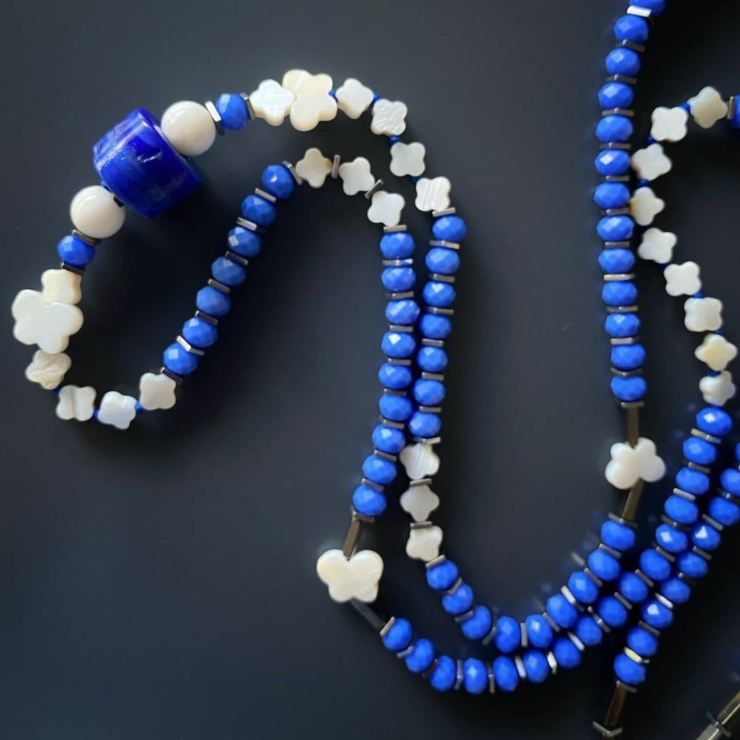Sacred Geometry-inspired Flower of Life Necklace - Handmade jewelry piece with a 925 Solid Silver pendant, blue crystal beads, and silver hematite spacers, representing the interconnectedness of all beings.