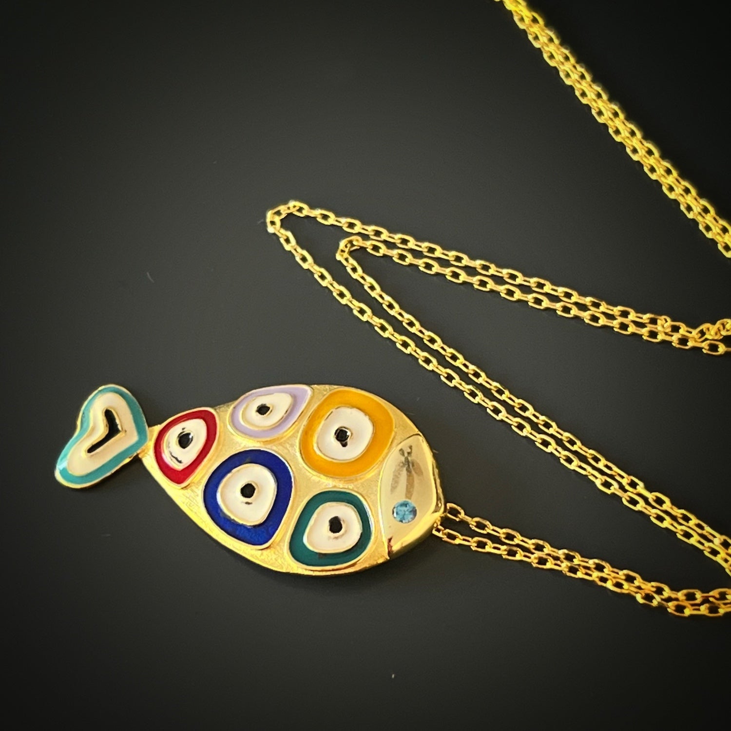 Colorful Enamel Evil Eye Fish Necklace - Eye-catching necklace with a fish pendant and intricate evil eye designs, handmade from 925 Sterling silver on 18K gold plated chain.