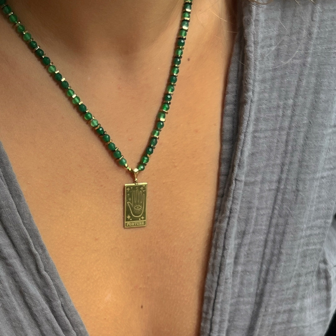 Model Wearing Good Fortune Tarot Necklace - A photo of a model wearing the Good Fortune Tarot Necklace, showcasing how the necklace beautifully adorns the neckline.