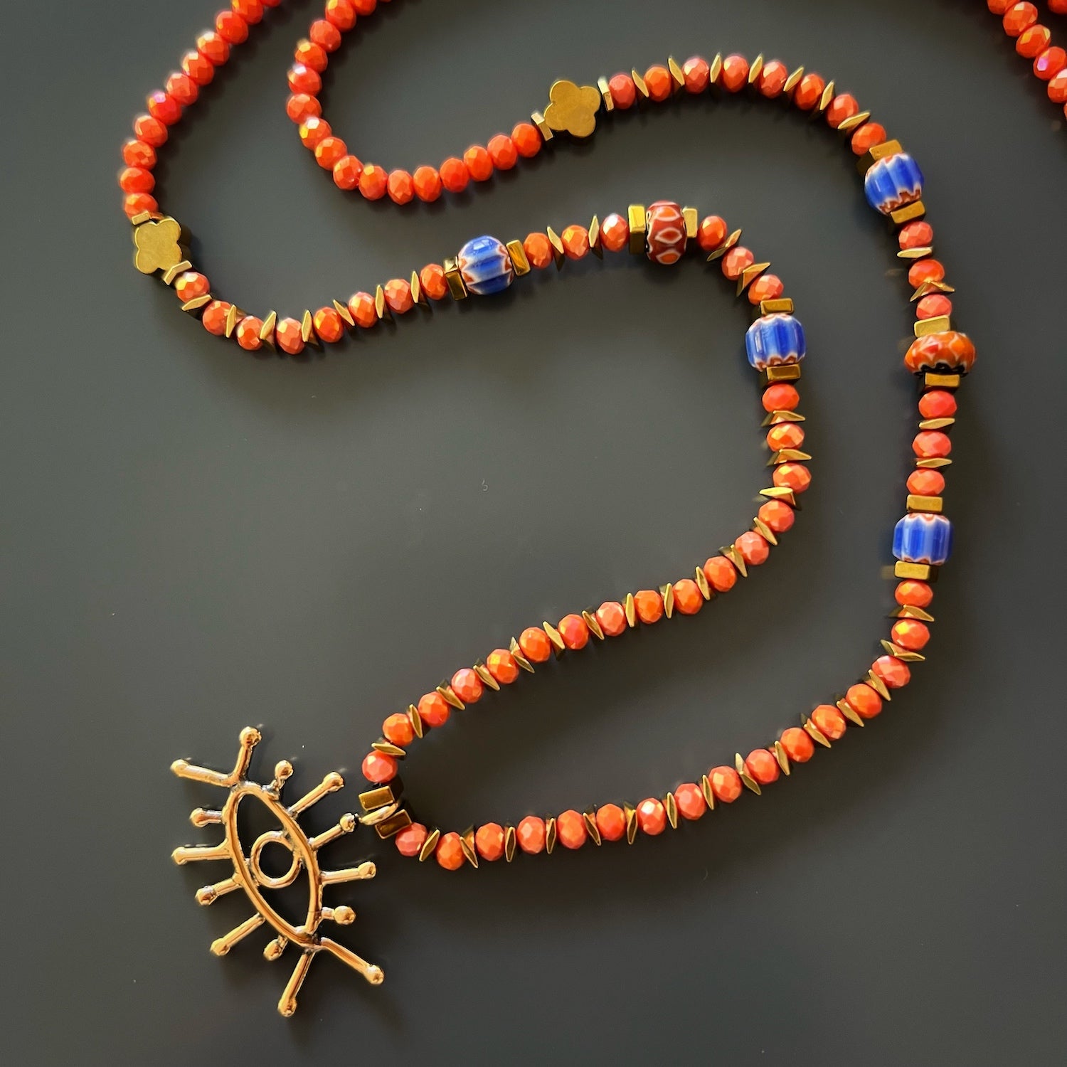 Eye-catching Good Vibes Eye Necklace with colorful African beads and gold hematite stone flower beads
