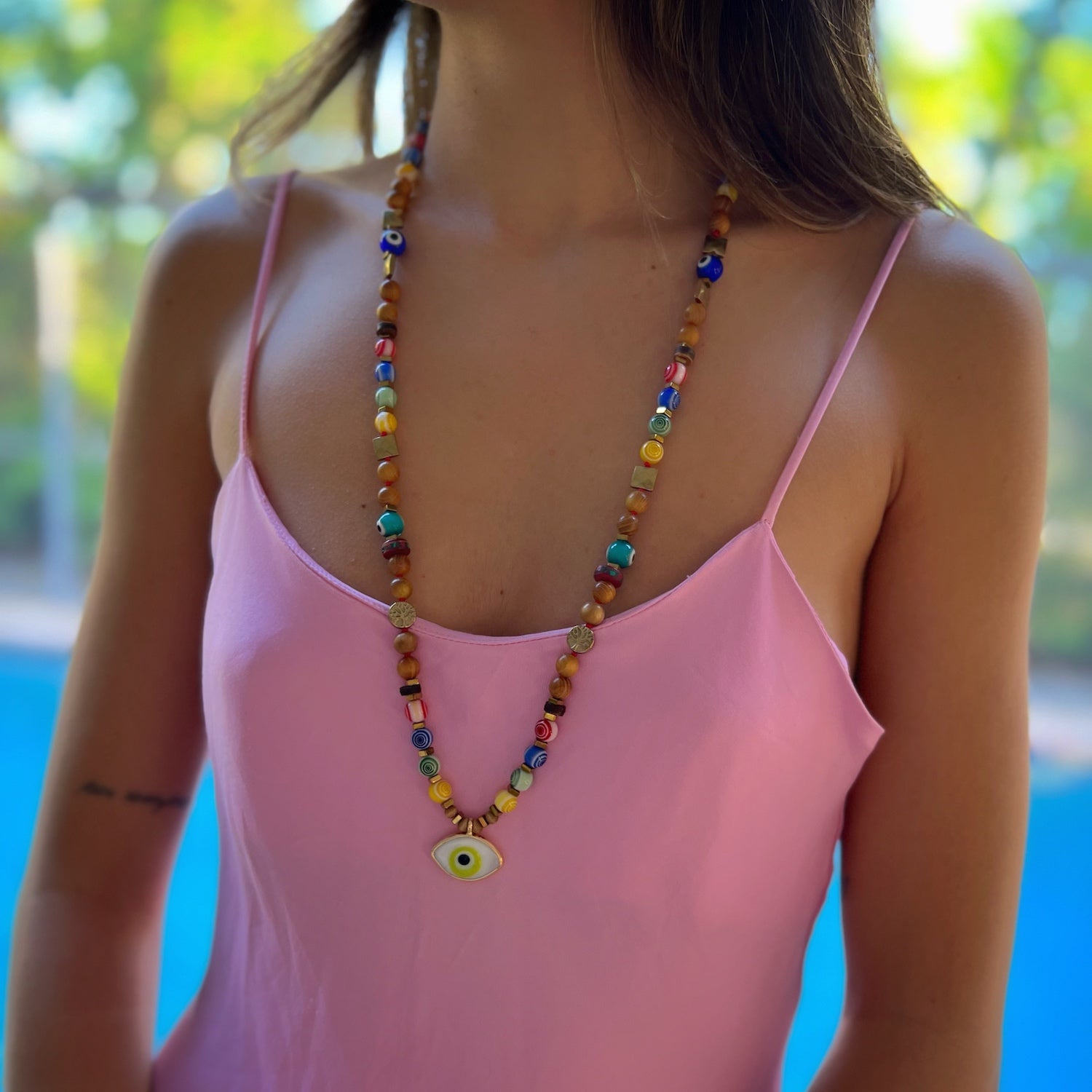 Model wearing the Green Eye Beaded Necklace, showcasing its vibrant colors and unique design.