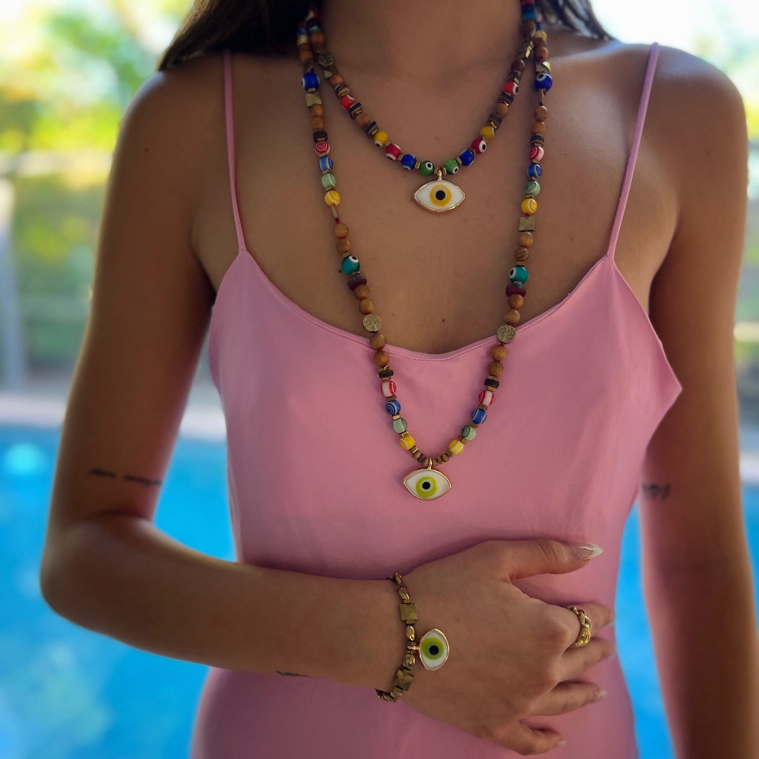 Model wearing the Green Eye Beaded Necklace, highlighting its versatility.