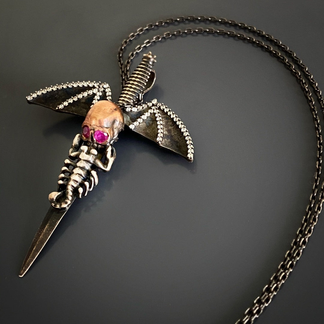 Skull Pendant Necklace with Ruby Eyes - Make a statement with this unique and meticulously crafted silver skull pendant necklace, adorned with ruby stones for captivating eyes and rhodium-plated for lasting shine.