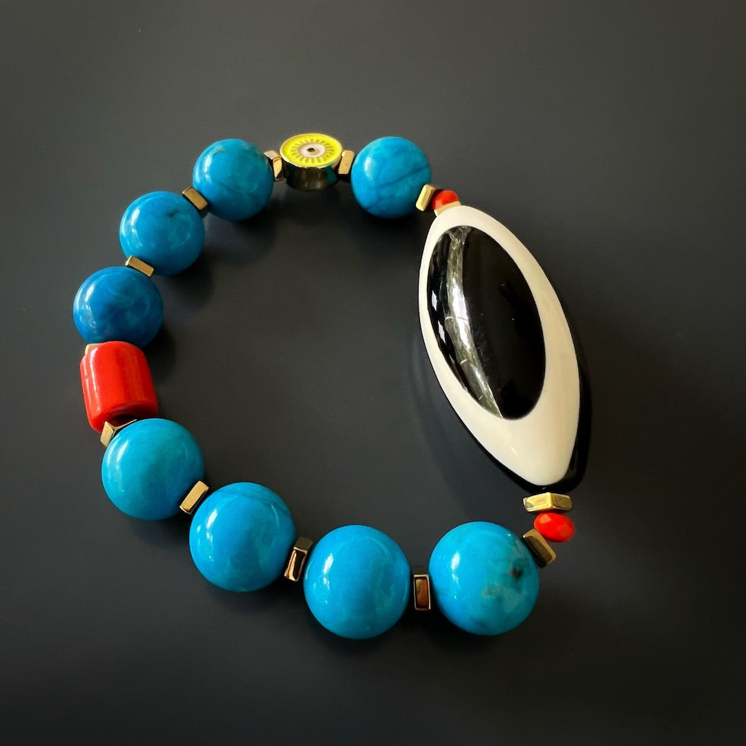 the Happiness Turquoise Eye Bracelet, displaying the beautiful arrangement of the turquoise beads, orange color African bead, and gold color hematite stone spacers, creating a vibrant and eye-catching composition.