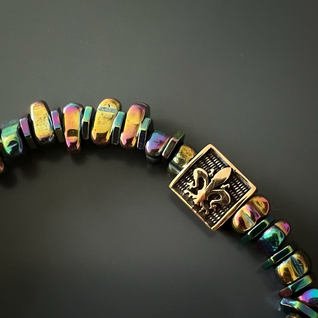 Adorn your wrist with the Hematite Floral Bracelet, adorned with multicolor Hematite stone beads and gold floral accents.