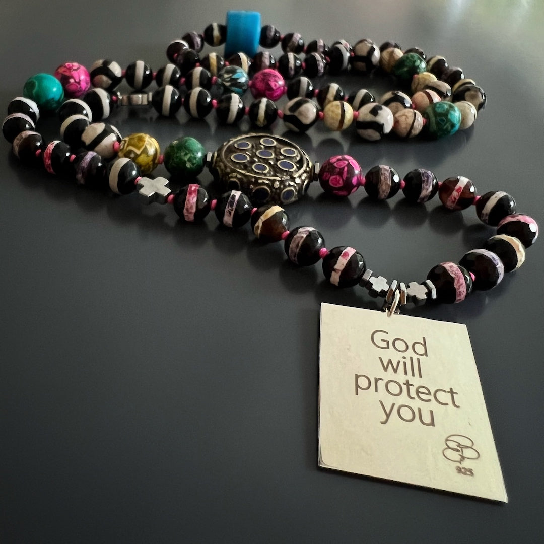 The I Am Always Protected Necklace, a symbol of luck and protection, beautifully displayed in this image.