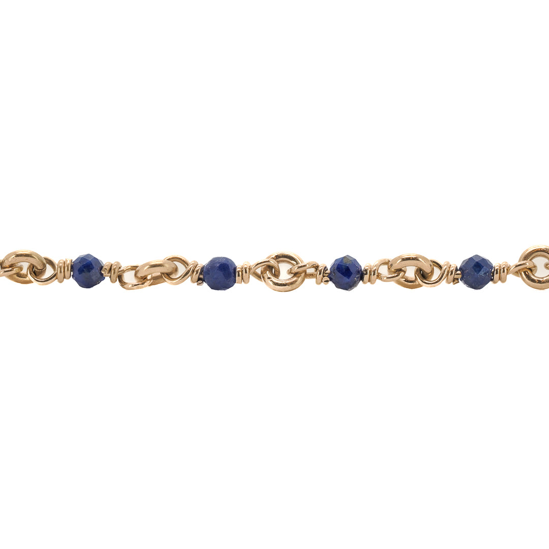 The Karya Lapis Gold Necklace elegantly drapes around the neck, adding a touch of sophistication and style to the overall look.