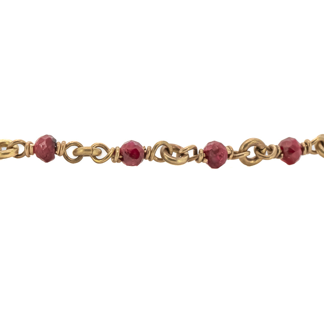 The Karya Ruby Gold Necklace delicately drapes around the neck, adding a touch of elegance and glamour to the overall look.