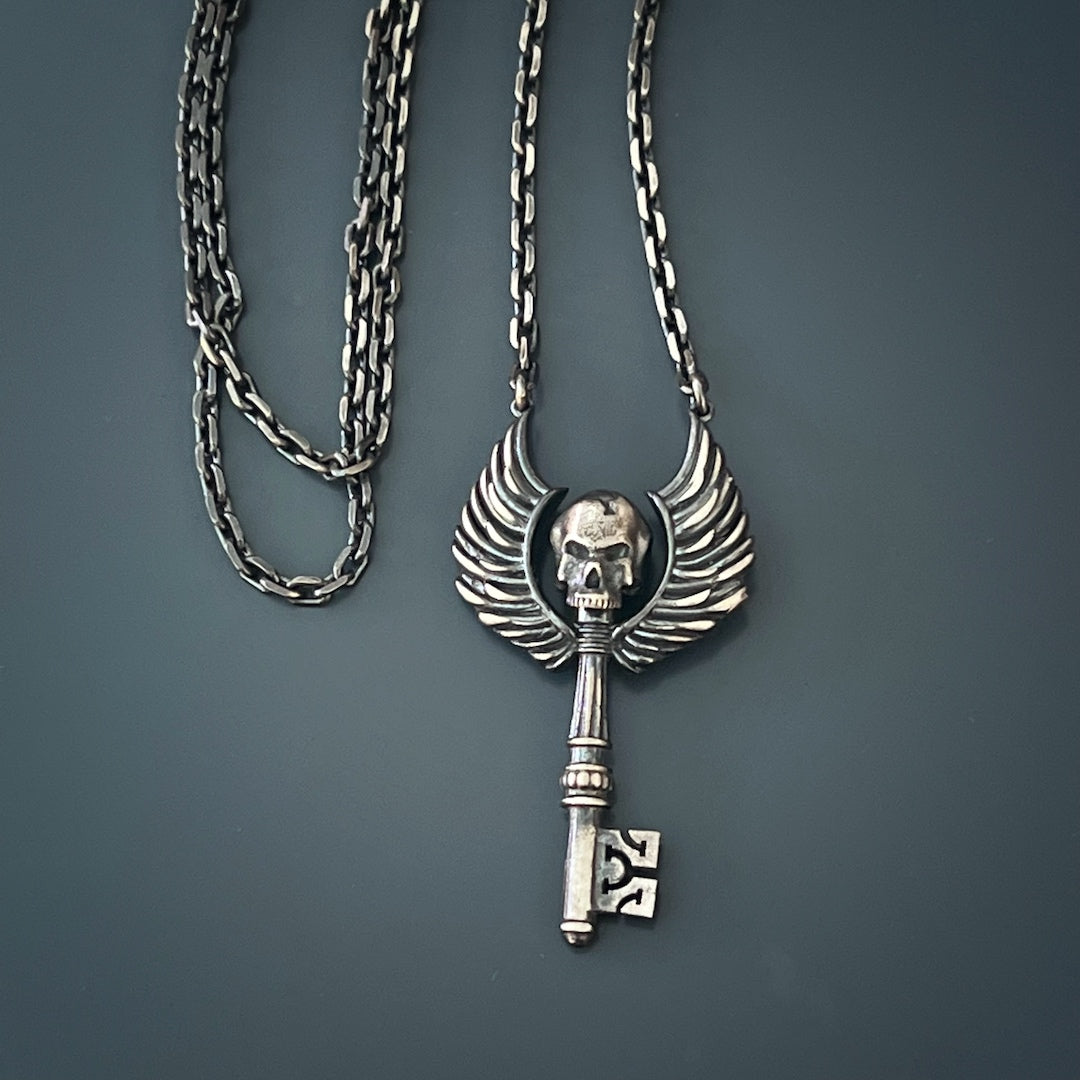The Key Skull Silver Necklace on display, capturing attention with its striking design and the allure of sterling silver craftsmanship.