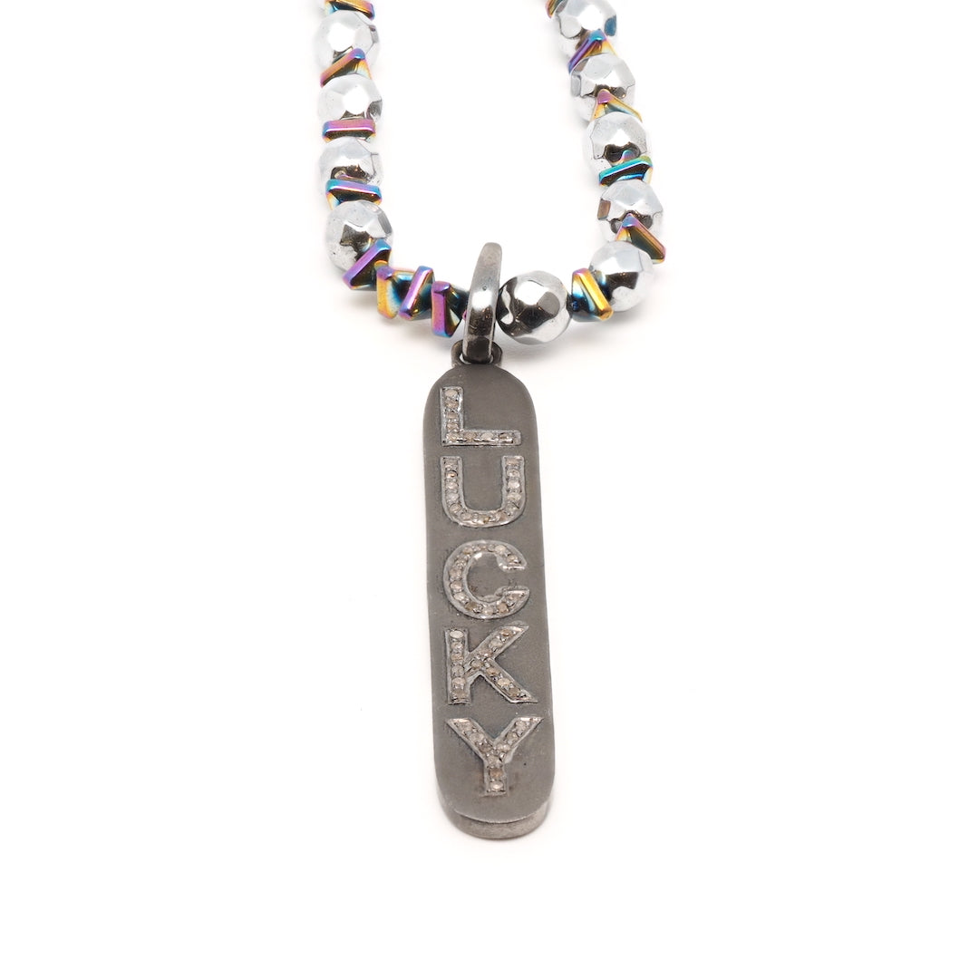 Shiny hematite stones and a sparkling diamond pendant come together in the Light of Luck Diamond Necklace, creating an enchanting and glamorous accessory.