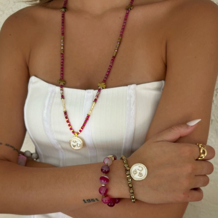 Model wearing: Embrace the positive energy of the Magic Blessings Pink Necklace, radiating confidence and style with its symbolic charms and vibrant hot pink jade stone beads.