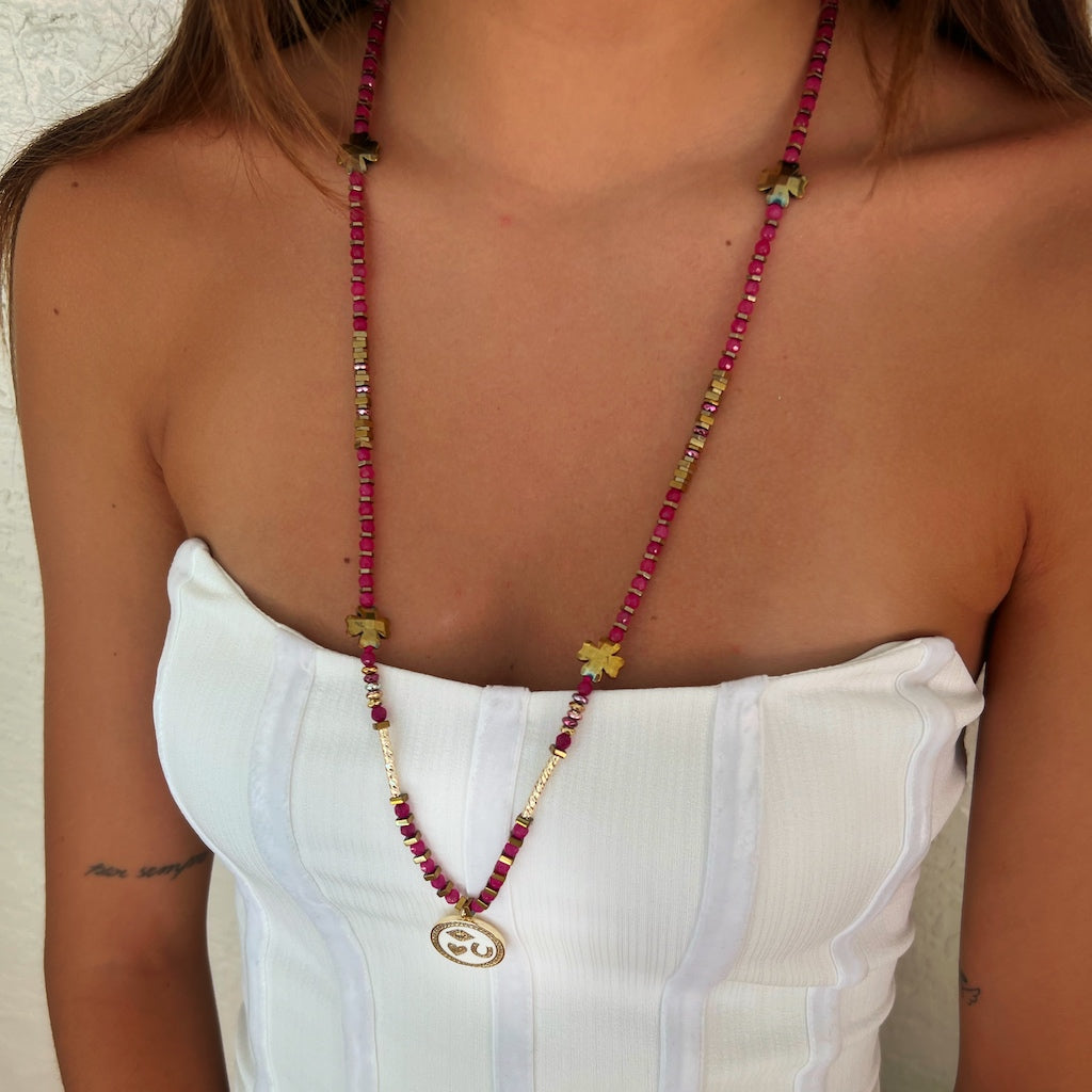 Model wearing: Enhance your aura with the Magic Blessings Pink Necklace, exuding elegance and grace while showcasing the protective symbols and enchanting beauty of the handcrafted piece.