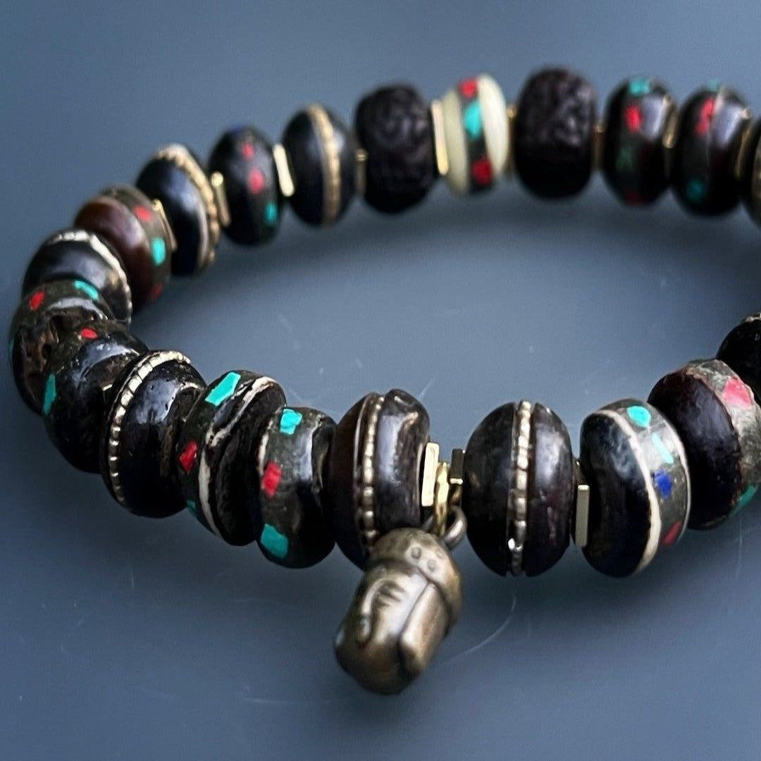 Elevate your meditation practice with the Meditation Bracelet, crafted with inlaid Nepal yak bone beads and a symbolic Buddha charm.