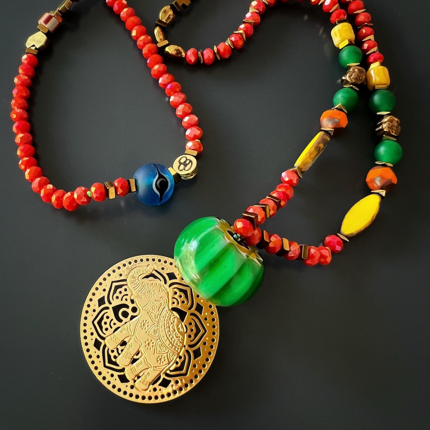 the Mystic Bohemian Elephant Necklace, demonstrating how it can elevate any bohemian-inspired outfit, as the necklace adds a pop of color and the meaningful elephant pendant to her ensemble.