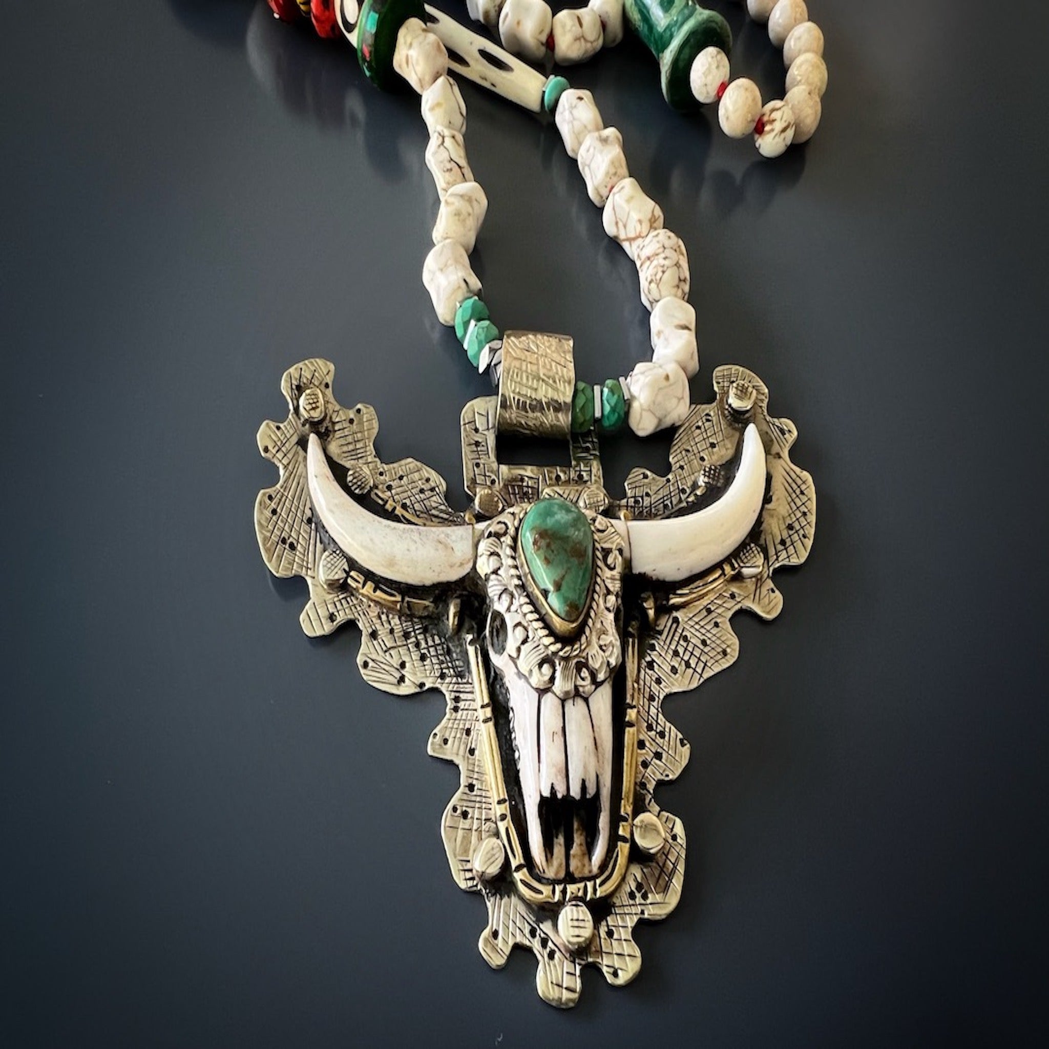 the Mystic Longhorn Unique Necklace, highlighting the beautiful carved longhorn pendant and the combination of colorful beads, creating a captivating and eye-catching accessory.