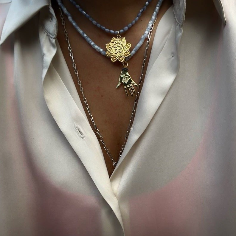The model exudes confidence and grace, wearing the necklace with pride.