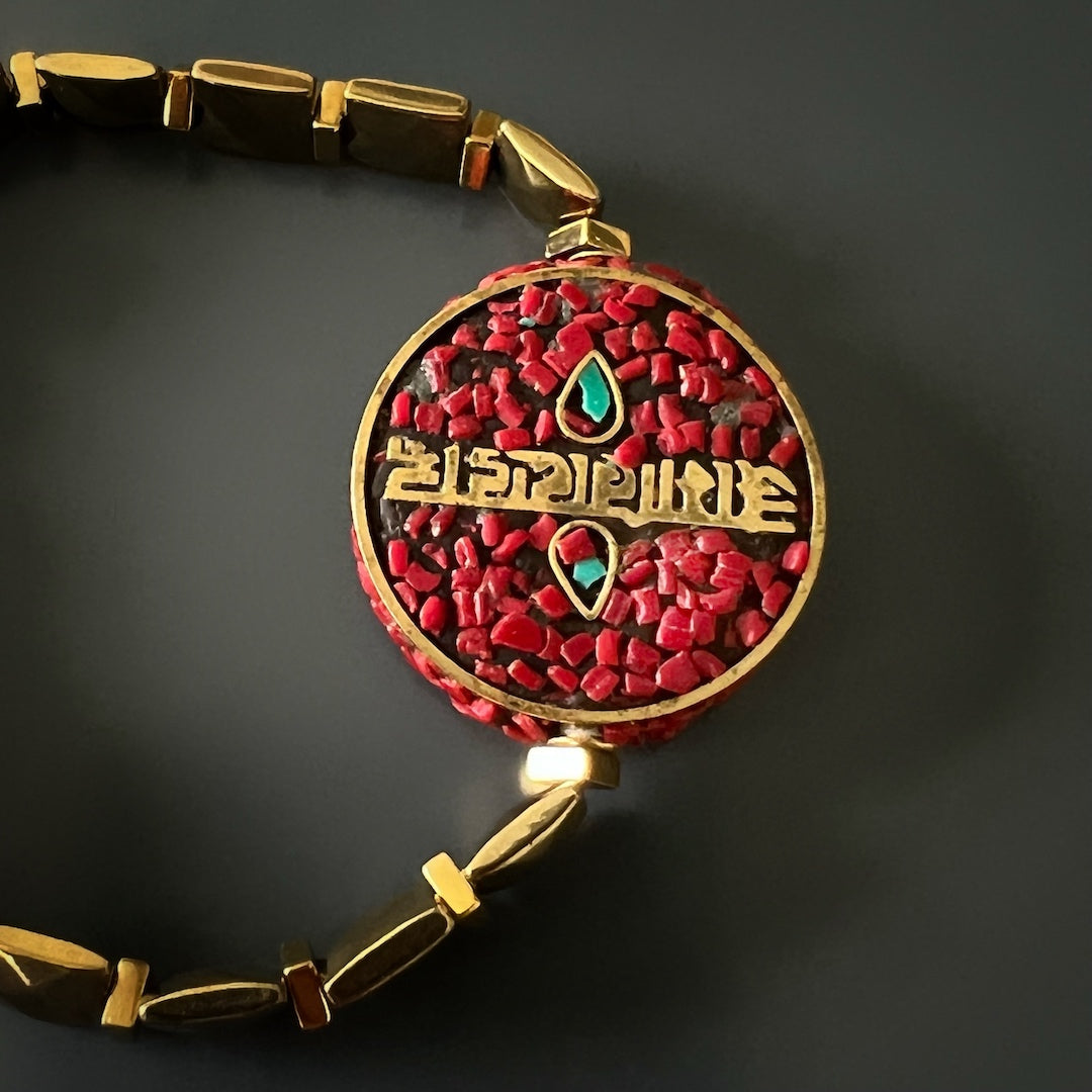 Experience the power of protection with the Om Mani Padme Hum Coral Mantra Bracelet, adorned with a red coral and turquoise inlay mantra bead.