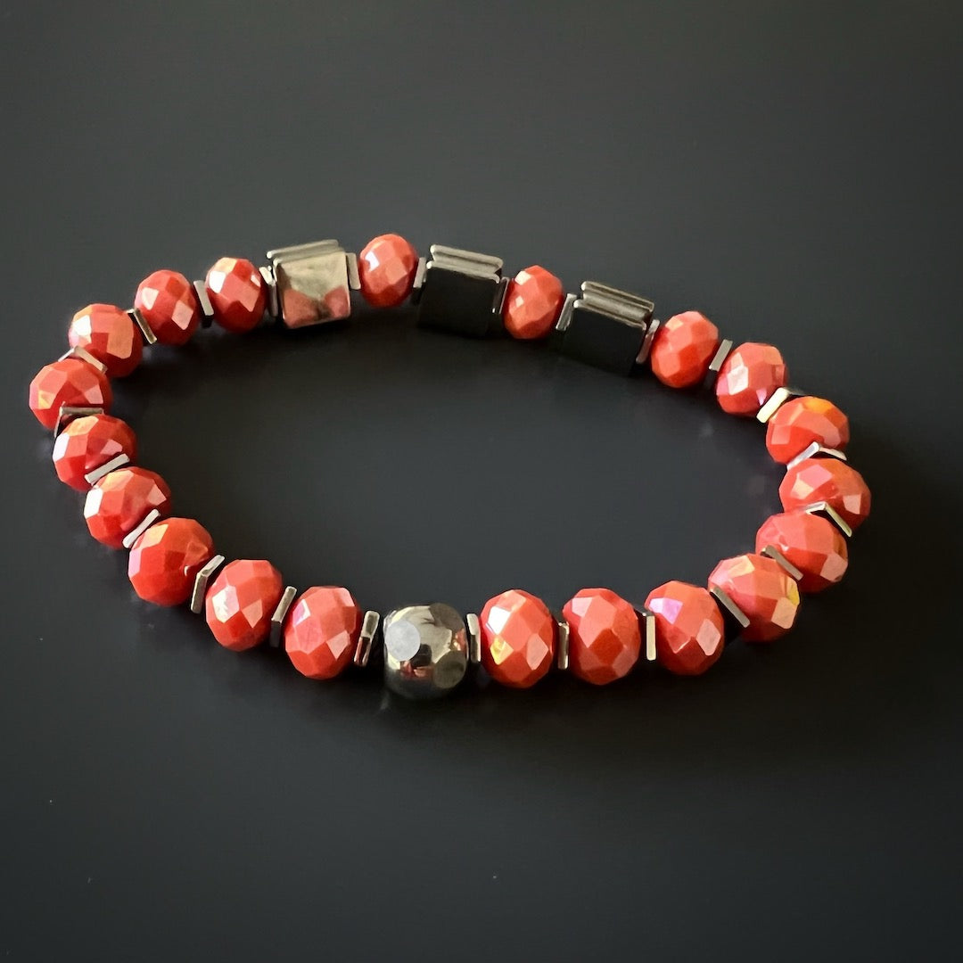 Celebrate the power of color and energy with the Orange Energy Bracelet, featuring orange crystal beads and stylish silver hematite stone beads.