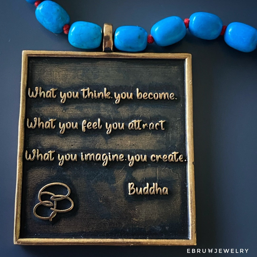 Handcrafted necklace with turquoise beads and a pendant carrying inspiring words of Ganesha and Buddha.