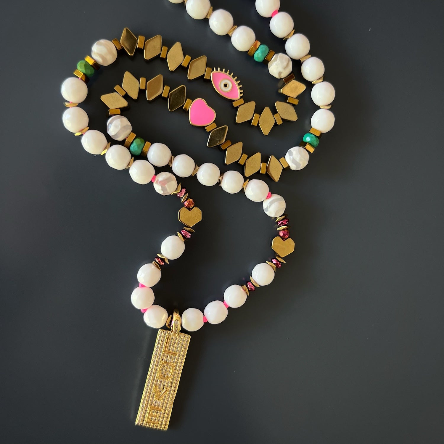 Close-up shot of the Jade beads on the Power Of Love Necklace, symbolizing purity and tranquility.